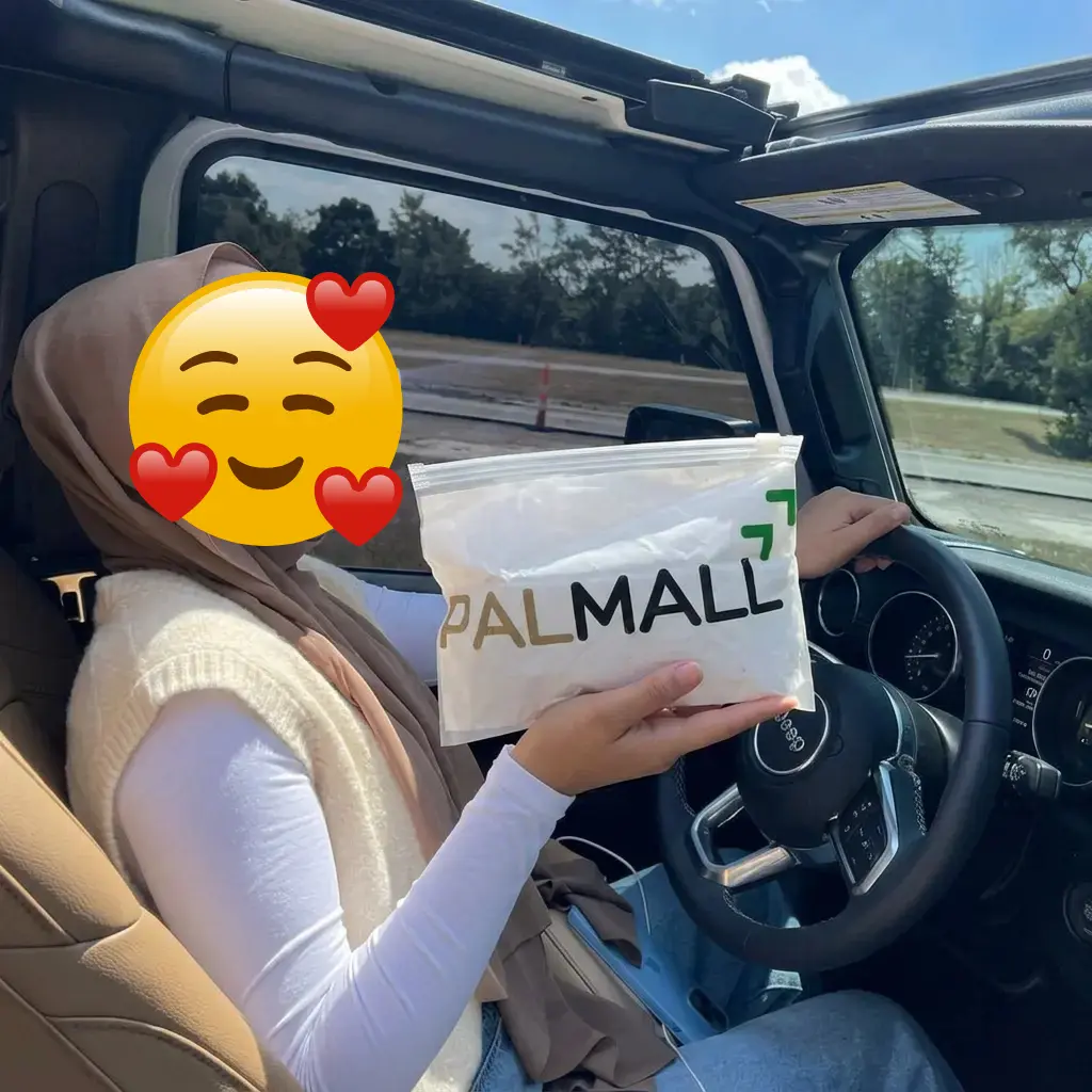 Cliente tenant la pochette PALMALL dans une voiture